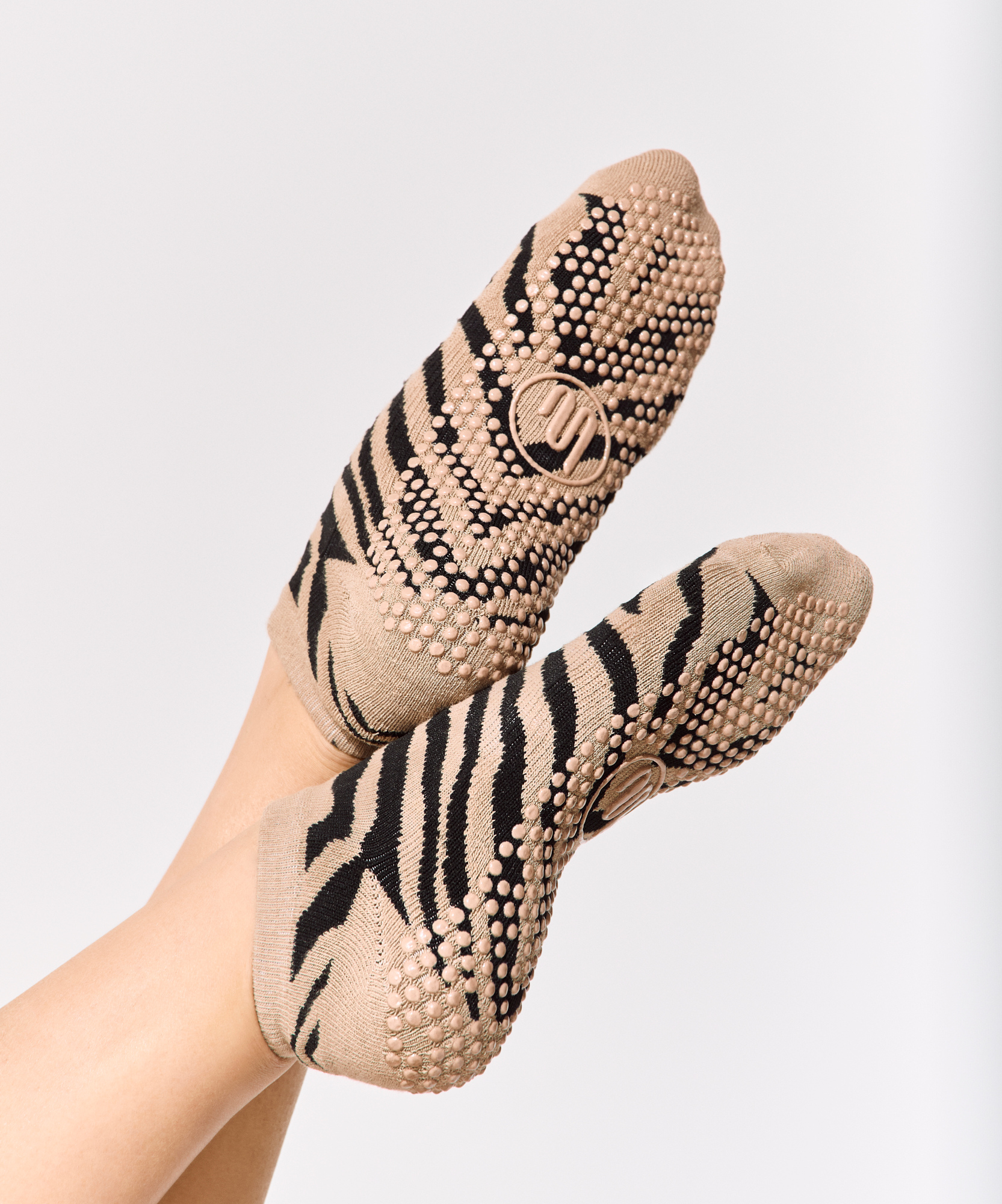 Close up of the non-slip sole of the low rise grip sock in zebra print